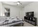 Spacious bedroom with a ceiling fan, a large window and a tv stand with shelves at 2425 W Bronco Butte Trl # 2011, Phoenix, AZ 85085