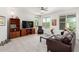 Bright living room with plush carpeting, ceiling fan, and view of backyard at 2425 W Bronco Butte Trl # 2011, Phoenix, AZ 85085
