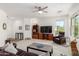 Spacious living room with ceiling fan, plush carpeting, and media center at 2425 W Bronco Butte Trl # 2011, Phoenix, AZ 85085