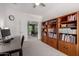 Inviting office space featuring built-in bookshelves and french doors leading to the patio at 2425 W Bronco Butte Trl # 2011, Phoenix, AZ 85085