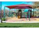 Community playground featuring modern play equipment under a shaded canopy for safe and fun activities at 2425 W Bronco Butte Trl # 2011, Phoenix, AZ 85085