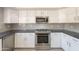 Bright kitchen featuring stainless steel appliances, gray countertops, and white cabinetry at 26286 N 45Th Pl, Phoenix, AZ 85050