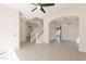 Spacious living room featuring tile flooring, a staircase, archways, and modern lighting fixtures at 26286 N 45Th Pl, Phoenix, AZ 85050