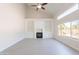 Bright living room featuring a fireplace, built-in shelves, tile flooring, and large windows at 26286 N 45Th Pl, Phoenix, AZ 85050