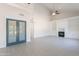 Open concept living room featuring a fireplace, built-in shelving, and large double doors at 26286 N 45Th Pl, Phoenix, AZ 85050
