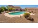 Backyard featuring a large pool surrounded by desert landscaping, offering a private retreat at 26286 N 45Th Pl, Phoenix, AZ 85050