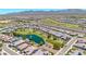 Panoramic aerial view showcasing a residential community and its proximity to a lush golf course at 27606 W Tonopah Dr, Buckeye, AZ 85396