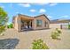 Backyard view of the house featuring a covered back patio and desert landscaping at 27606 W Tonopah Dr, Buckeye, AZ 85396