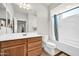 Bathroom with a white vanity, wood cabinets, a shower/tub combo and good natural lighting at 27606 W Tonopah Dr, Buckeye, AZ 85396