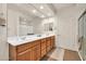 Bathroom features a double vanity, large mirror, and tile flooring at 27606 W Tonopah Dr, Buckeye, AZ 85396