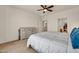 Cozy bedroom features a ceiling fan, neutral decor, and a light-colored dresser at 27606 W Tonopah Dr, Buckeye, AZ 85396