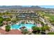 Aerial view of the beautiful community pool, surrounded by palm trees and well-manicured grounds at 27606 W Tonopah Dr, Buckeye, AZ 85396