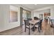 Bright dining area featuring sliding glass door access to a patio and stylish wood-look flooring at 27606 W Tonopah Dr, Buckeye, AZ 85396