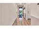 Inviting hallway with wood-look flooring, neutral walls, and a view of the front yard through the front door at 27606 W Tonopah Dr, Buckeye, AZ 85396