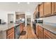 Spacious kitchen showcasing granite countertops, stainless appliances, and an adjacent pantry at 27606 W Tonopah Dr, Buckeye, AZ 85396