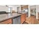 Kitchen island boasts a stainless steel dishwasher and gorgeous granite countertops and sink at 27606 W Tonopah Dr, Buckeye, AZ 85396