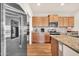 Kitchen features stainless steel appliances, wooden cabinets, granite countertops, and a pantry at 27606 W Tonopah Dr, Buckeye, AZ 85396