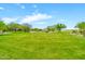 Picture of the community lawn surrounded by mature trees and the well-manicured golf course at 27606 W Tonopah Dr, Buckeye, AZ 85396
