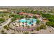 Aerial view of resort-style pool with surrounding palm trees and lounge chairs in the community at 27606 W Tonopah Dr, Buckeye, AZ 85396