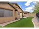 Cozy backyard featuring an outdoor grill, artificial turf, and desert landscaping for low maintenance enjoyment at 29751 N 119Th Ln, Peoria, AZ 85383