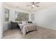 Bright bedroom features a ceiling fan, wood flooring, and a tranquil view from the bay window at 29751 N 119Th Ln, Peoria, AZ 85383