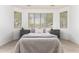 Bedroom boasting natural light from bay windows, paired with elegant gray nightstands and cozy bedding at 29751 N 119Th Ln, Peoria, AZ 85383