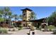Charming community entrance featuring a tower and covered walkway surrounded by lush desert landscaping at 29751 N 119Th Ln, Peoria, AZ 85383