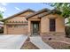 Charming single-story home with a two-car garage, stone accents, and a well-manicured front yard at 29751 N 119Th Ln, Peoria, AZ 85383