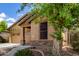 This home has a tan exterior, a two-car garage, desert landscaping, and stone accents at 29751 N 119Th Ln, Peoria, AZ 85383