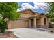 Attractive single-story house featuring a two-car garage, desert landscaping, and a welcoming front entrance at 29751 N 119Th Ln, Peoria, AZ 85383
