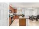 Modern kitchen features granite countertops, dark appliances, and wooden cabinets, and a serving island at 29751 N 119Th Ln, Peoria, AZ 85383