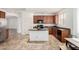 Well-lit kitchen boasts granite countertops, wood cabinets, and stainless-steel appliances at 29751 N 119Th Ln, Peoria, AZ 85383