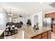 Open kitchen with granite countertops, stainless steel appliances, and seamless flow into the living area at 29751 N 119Th Ln, Peoria, AZ 85383