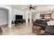 A modern living room featuring tile flooring, an open layout, and a seamless flow to the kitchen at 29751 N 119Th Ln, Peoria, AZ 85383