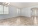 A bright, spacious room with large windows, tile flooring, and a modern chandelier at 29751 N 119Th Ln, Peoria, AZ 85383