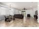 A spacious living room with tile flooring, a dining table, and sliding doors leading to the patio at 29751 N 119Th Ln, Peoria, AZ 85383