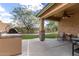 Inviting outdoor patio featuring a built-in grill, ceiling fan, and artificial turf at 29751 N 119Th Ln, Peoria, AZ 85383