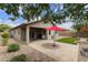 Backyard featuring a covered patio, neatly arranged brick pavers, and synthetic grass at 3067 E Merlot St, Gilbert, AZ 85298