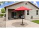 Covered patio featuring a paver floor, BBQ, red umbrella, and easy access to the house at 3067 E Merlot St, Gilbert, AZ 85298