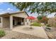 Paver patio and low-maintenance backyard with artificial turf and red umbrella at 3067 E Merlot St, Gilbert, AZ 85298