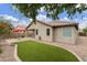 Lush backyard featuring green turf, a red umbrella, and desert landscaping at 3067 E Merlot St, Gilbert, AZ 85298