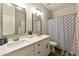 Bathroom featuring a double vanity with modern fixtures and a shower curtain for privacy at 3067 E Merlot St, Gilbert, AZ 85298