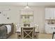 Dining area features a wooden table with seating for six and a large window providing natural light at 3067 E Merlot St, Gilbert, AZ 85298