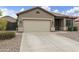 Inviting single-story home with a two-car garage, complemented by low-maintenance landscaping and a neutral color palette at 3067 E Merlot St, Gilbert, AZ 85298