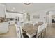 Spacious kitchen featuring white cabinets, stainless steel appliances, quartz countertops, and a connected dining area at 3067 E Merlot St, Gilbert, AZ 85298