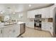 Modern kitchen with white cabinets, stainless steel appliances, quartz countertops and open to the dining area at 3067 E Merlot St, Gilbert, AZ 85298