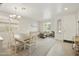 Bright and open living space with neutral walls, carpeting, large windows, and access to the dining area at 3067 E Merlot St, Gilbert, AZ 85298