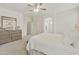 Bright main bedroom featuring carpet floors, a dresser, and ensuite bathroom access for convenience at 3067 E Merlot St, Gilbert, AZ 85298