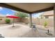 Paver patio with small table, chairs, mature landscaping and view of surrounding neighborhood at 3067 E Merlot St, Gilbert, AZ 85298