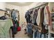 Organized walk-in closet with ample hanging space and shelving for clothes, shoes, and accessories at 3067 E Merlot St, Gilbert, AZ 85298